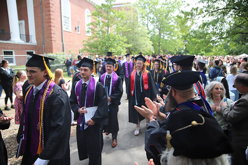 Faculty congratulating new graduates