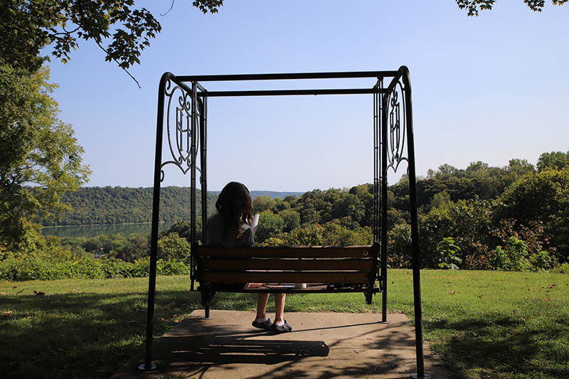 Student studying in a campus swing